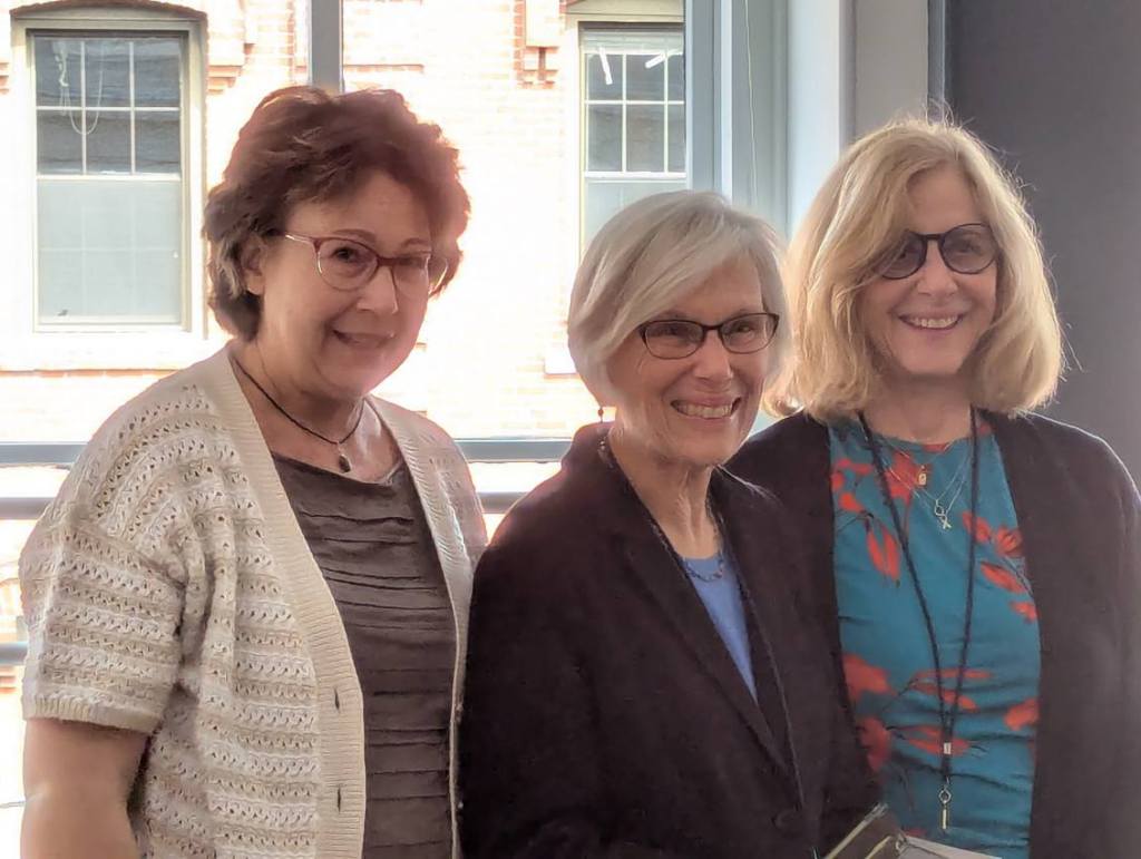 Three women posing together during the Nursing Journal Hall of Fame Ceremony, smiling and dressed in formal attire.